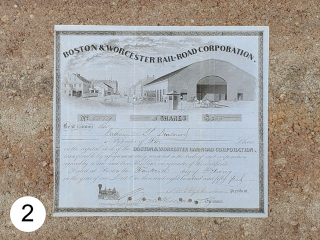 1854 stock certificate of the Boston & Worcester Rail-Road photographed against concrete